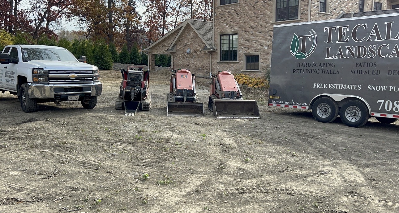 Tecalero Landscaping truck, equipment trailer and track loaders on a job site